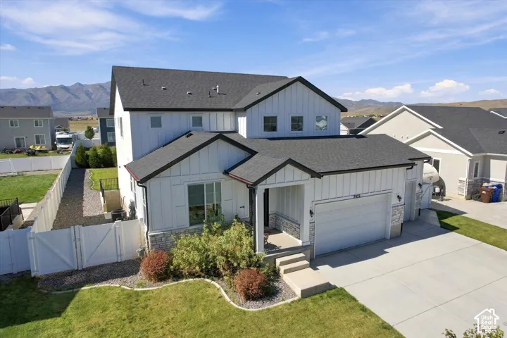 Contemporary two-story exterior featuring vertical siding and stone accents