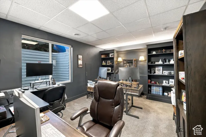 Built-in shelving, recessed lighting, and a drop ceiling