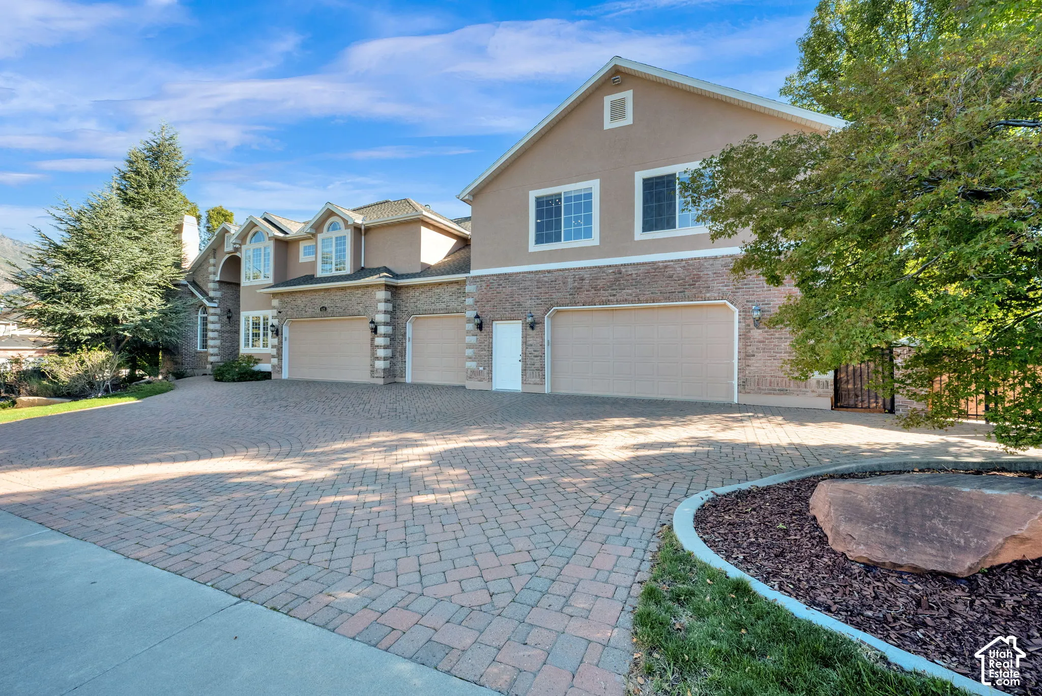 Stucco and brick exterior with multiple arched windows