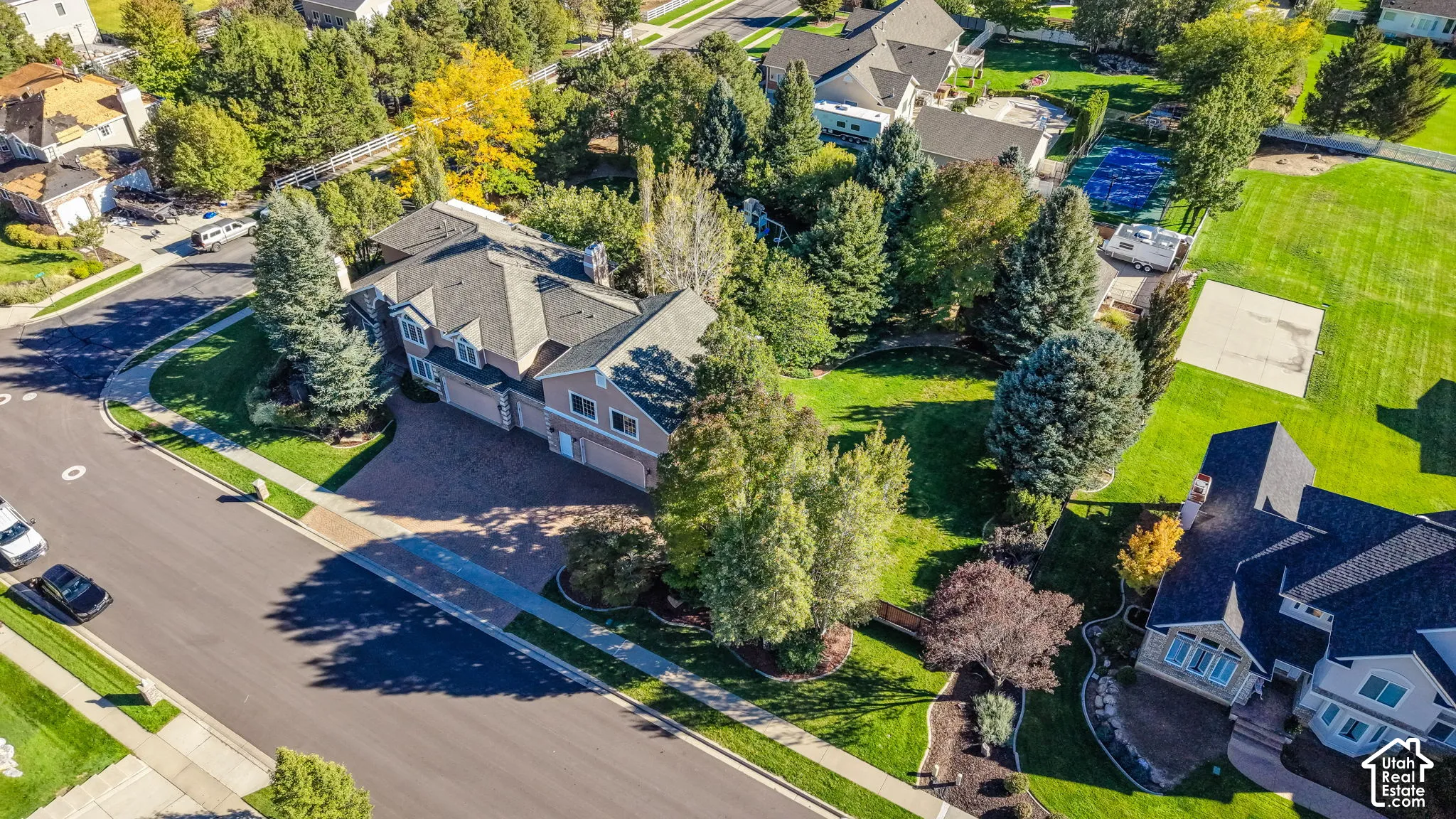 Traditional-style residence with a multi-car garage and a stone paver driveway
