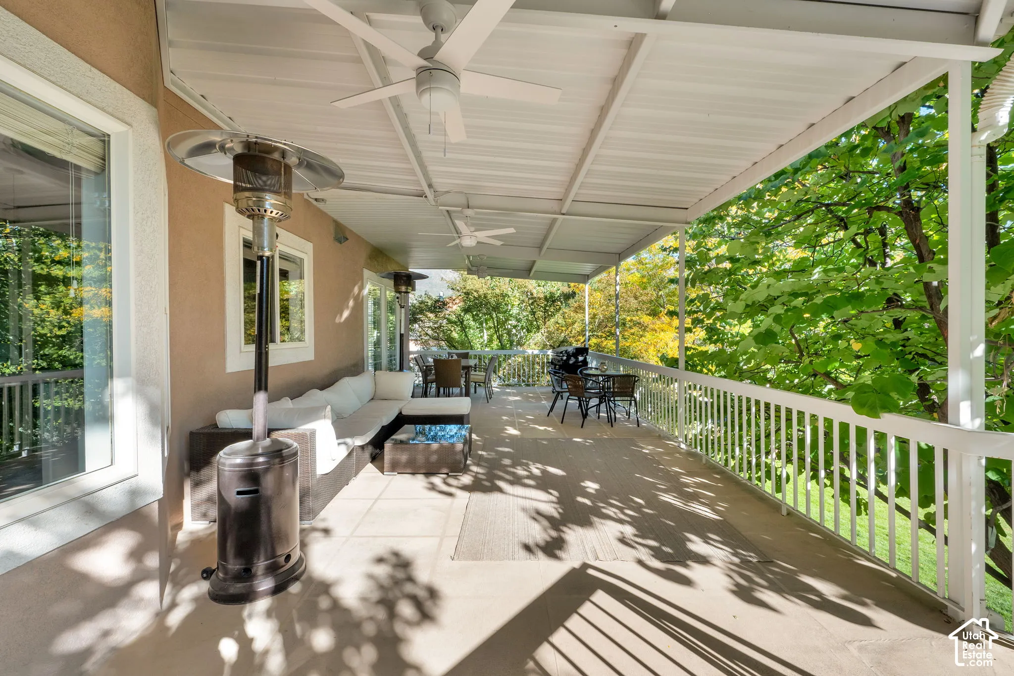 Covered outdoor patio with a durable railing system, ceiling fans, and a solid overhead structure