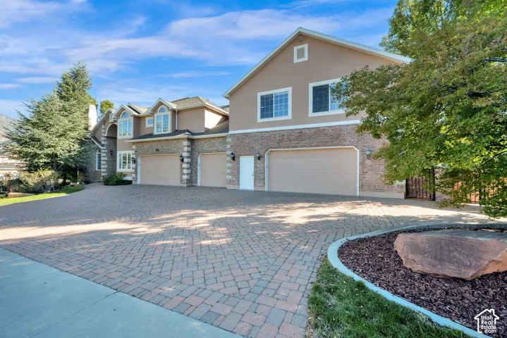 Stucco and brick exterior with multiple arched windows