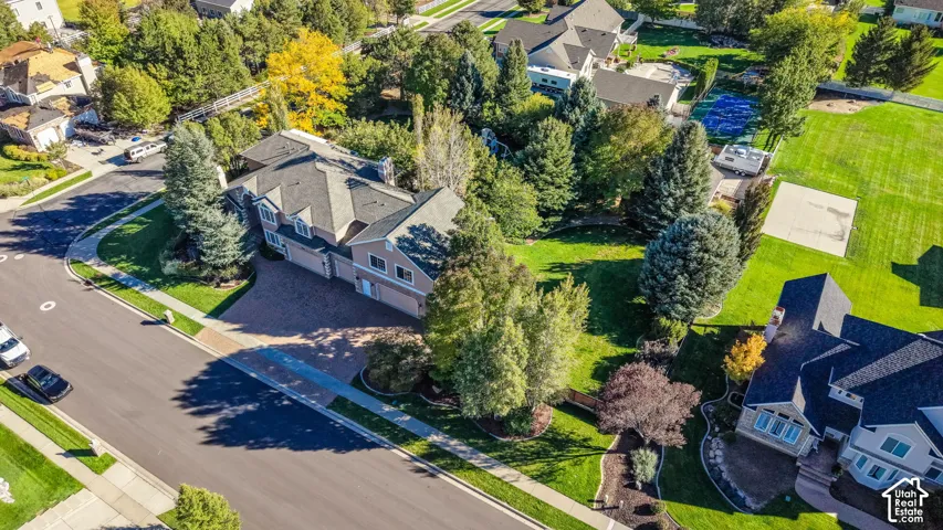 Traditional-style residence with a multi-car garage and a stone paver driveway
