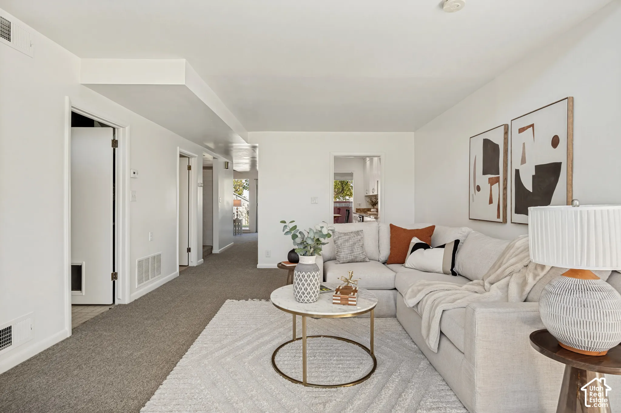 Bright living area with white walls and recessed lighting