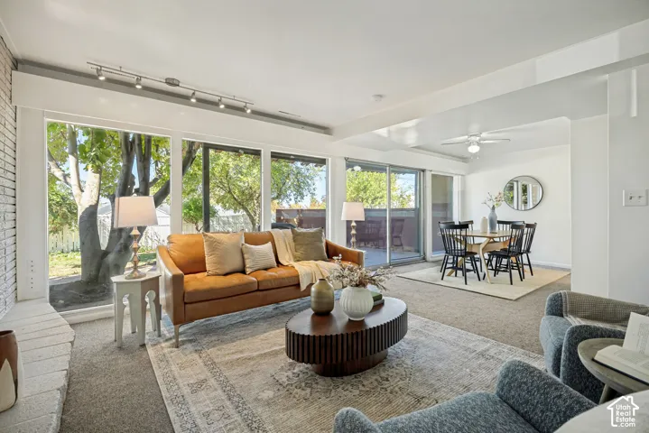 Expansive living area with large picture windows and a white brick fireplace