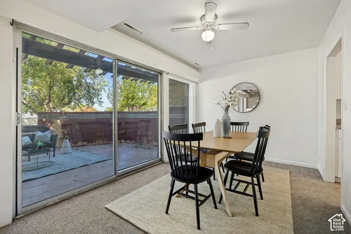 Sliding glass door leading to a patio with a pergola