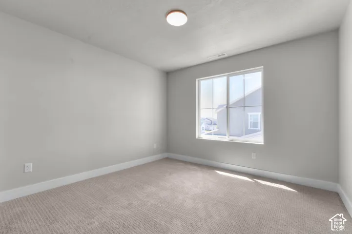 Neutral-toned walls complement plush carpeting