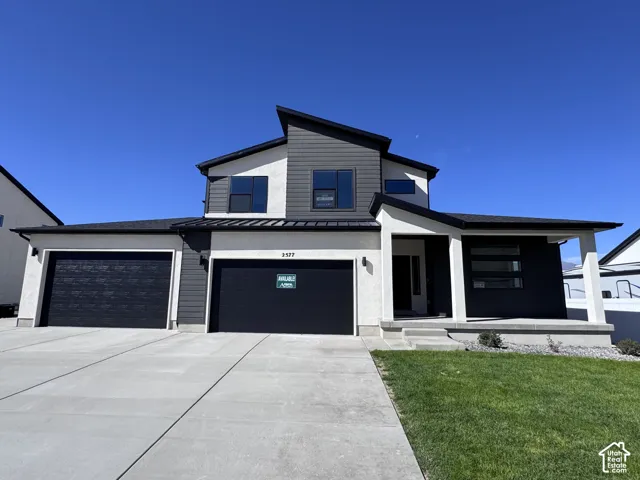Contemporary exterior with a covered porch, a two-car garage, and a concrete driveway