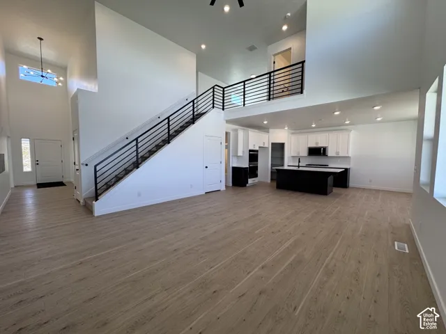 Expansive open-concept layout with light wood-finish flooring
