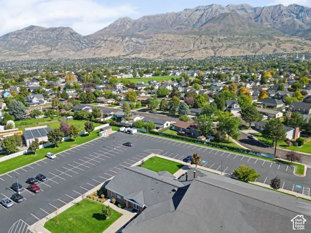 Expansive paved parking area with marked spaces and surrounding green spaces