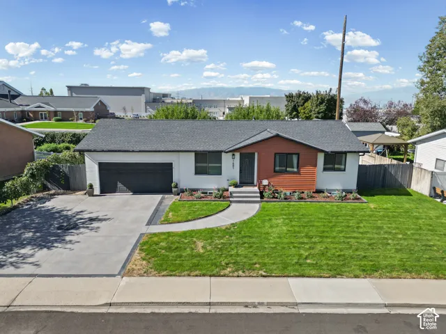 Single-story residence featuring a dark gray shingle roof and a two-car garage