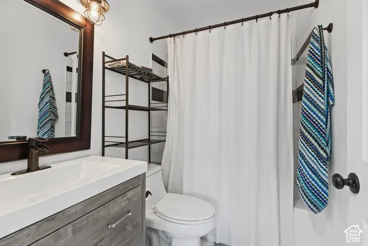 Wood-finish vanity with a white countertop and rectangular sink