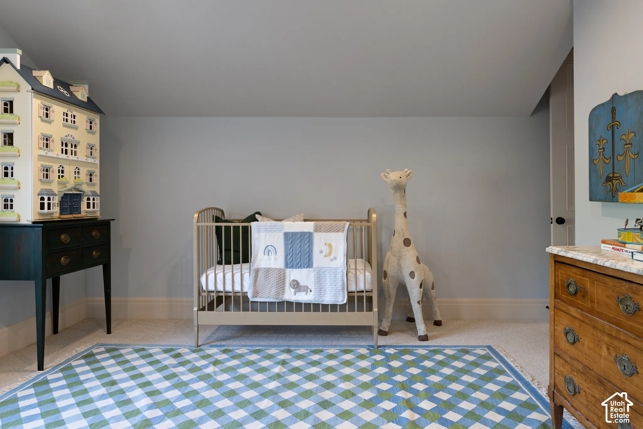 Carpeted flooring, light blue wall paint, white trim, recessed lighting, and a solid interior door