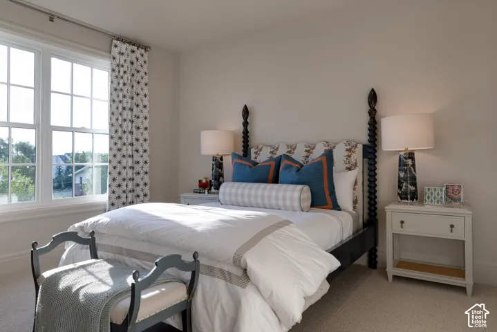 Double-hung windows, light neutral wall paint, and wall-to-wall carpeting