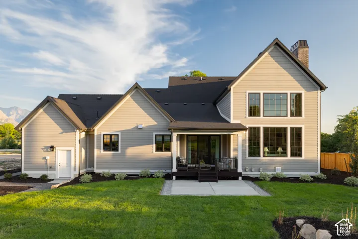 Contemporary home exterior with light-toned siding and dark-trimmed windows