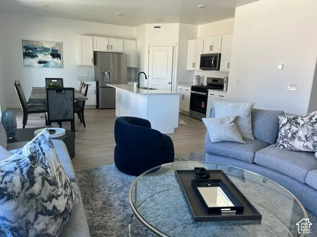 Open-concept living area with wood-finish flooring