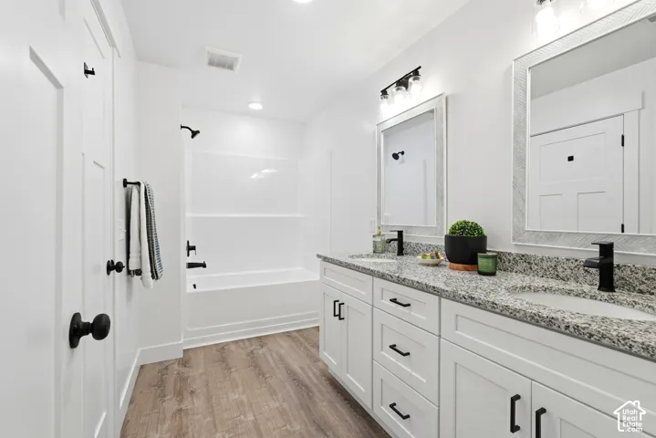 Dual vanity with granite countertops, undermount sinks, and matte black fixtures