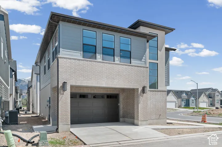 Contemporary exterior featuring light brick and horizontal siding