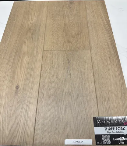 Wood-finish flooring featuring a warm-toned grain pattern and rigid core construction