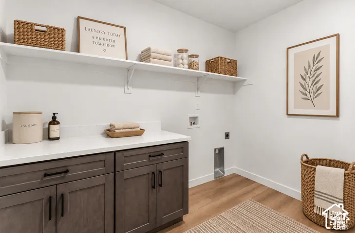 White walls, wood-finish flooring, two white floating shelves, dark wood-finish cabinetry, and a white countertop