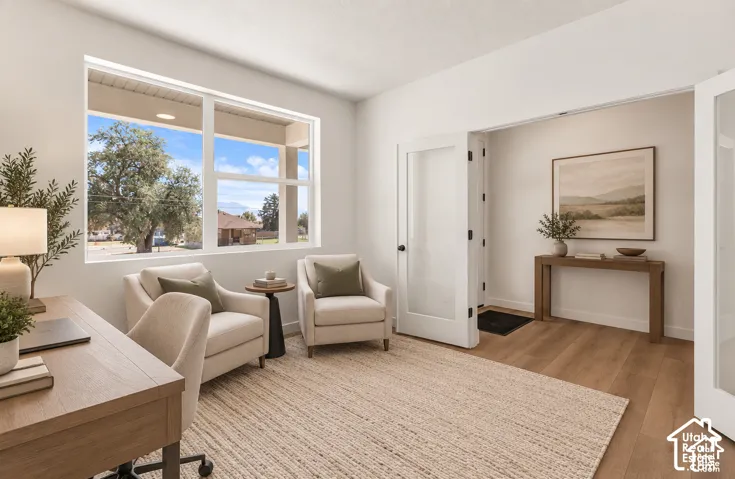 Expansive window, light wood-finish flooring, white walls, and frosted glass paneled doors