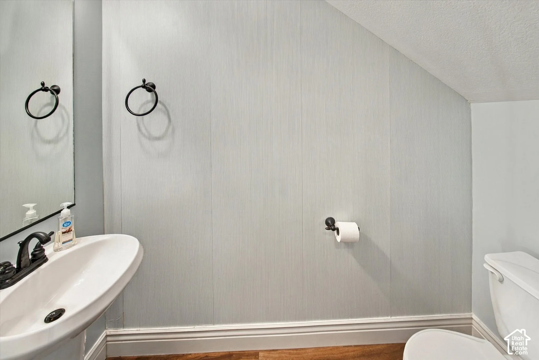 Pedestal sink with dark bronze faucet and hardware