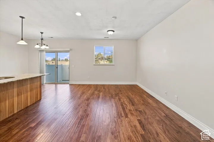 Wood-finish flooring throughout, with a built-in breakfast bar featuring a light-toned countertop