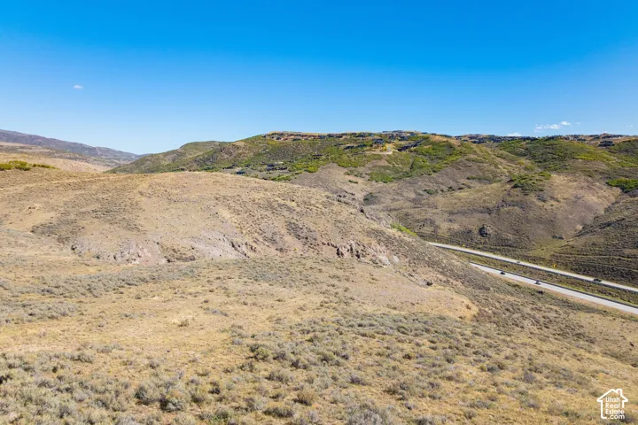 Expansive natural terrain featuring varied topography and distant mountainous backdrops