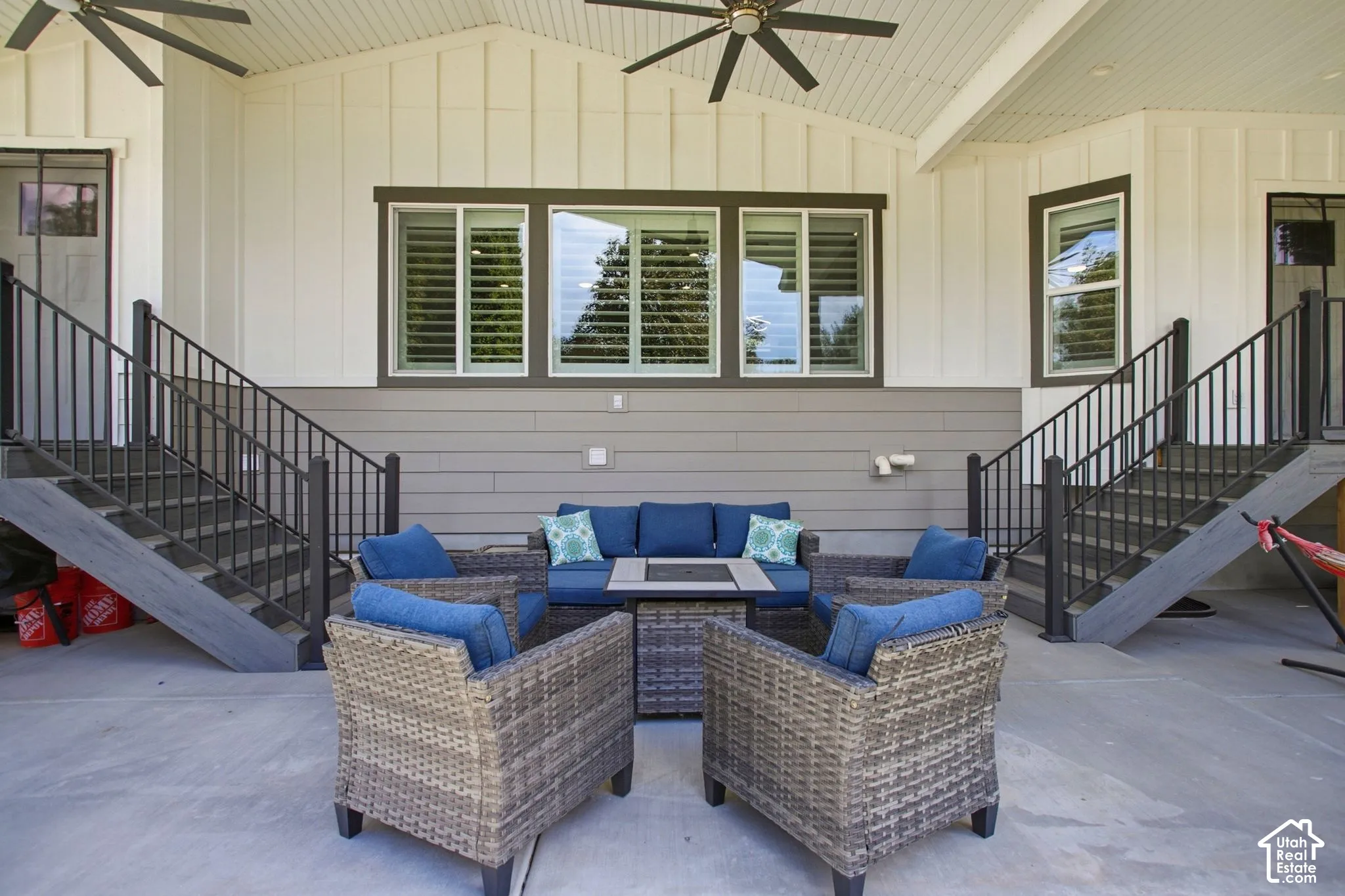 Covered patio with a concrete surface, two sets of exterior stairs
