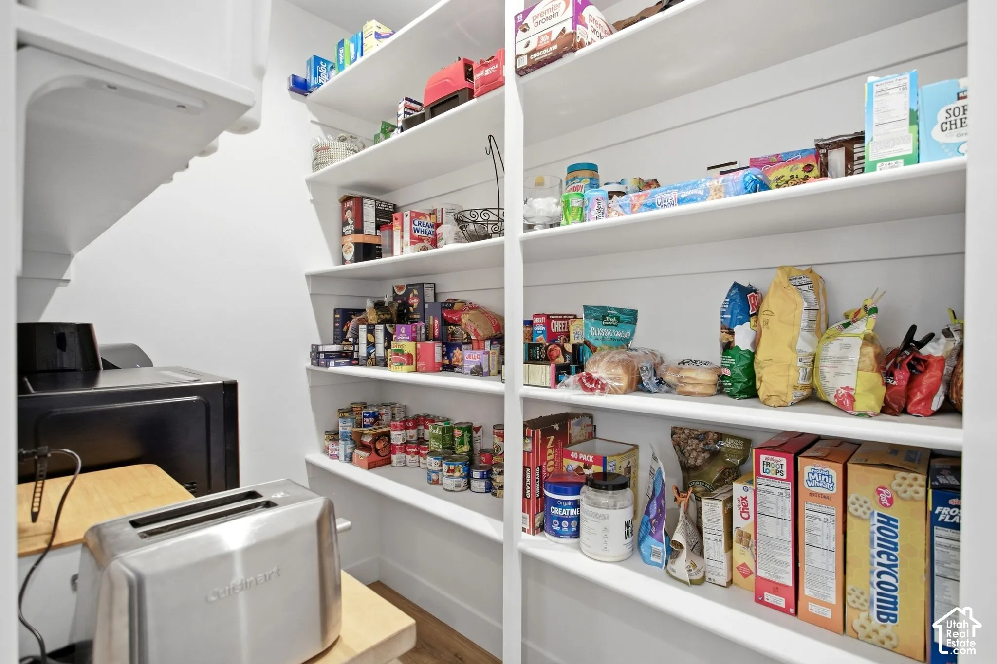 Walk-in butler pantry featuring extensive built-in shelving