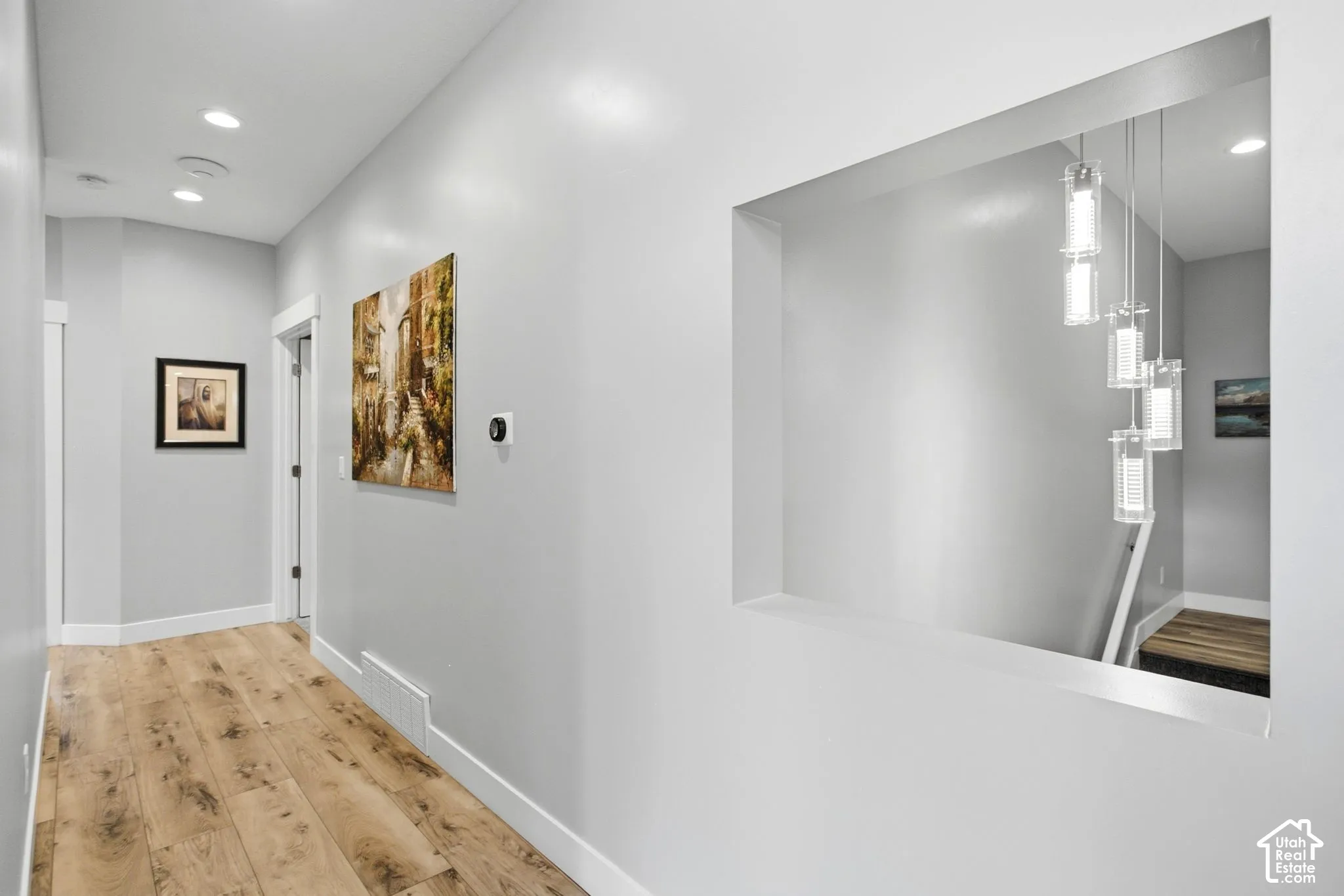 Wood-finish flooring, recessed lighting, and view of stairs going down to lower level