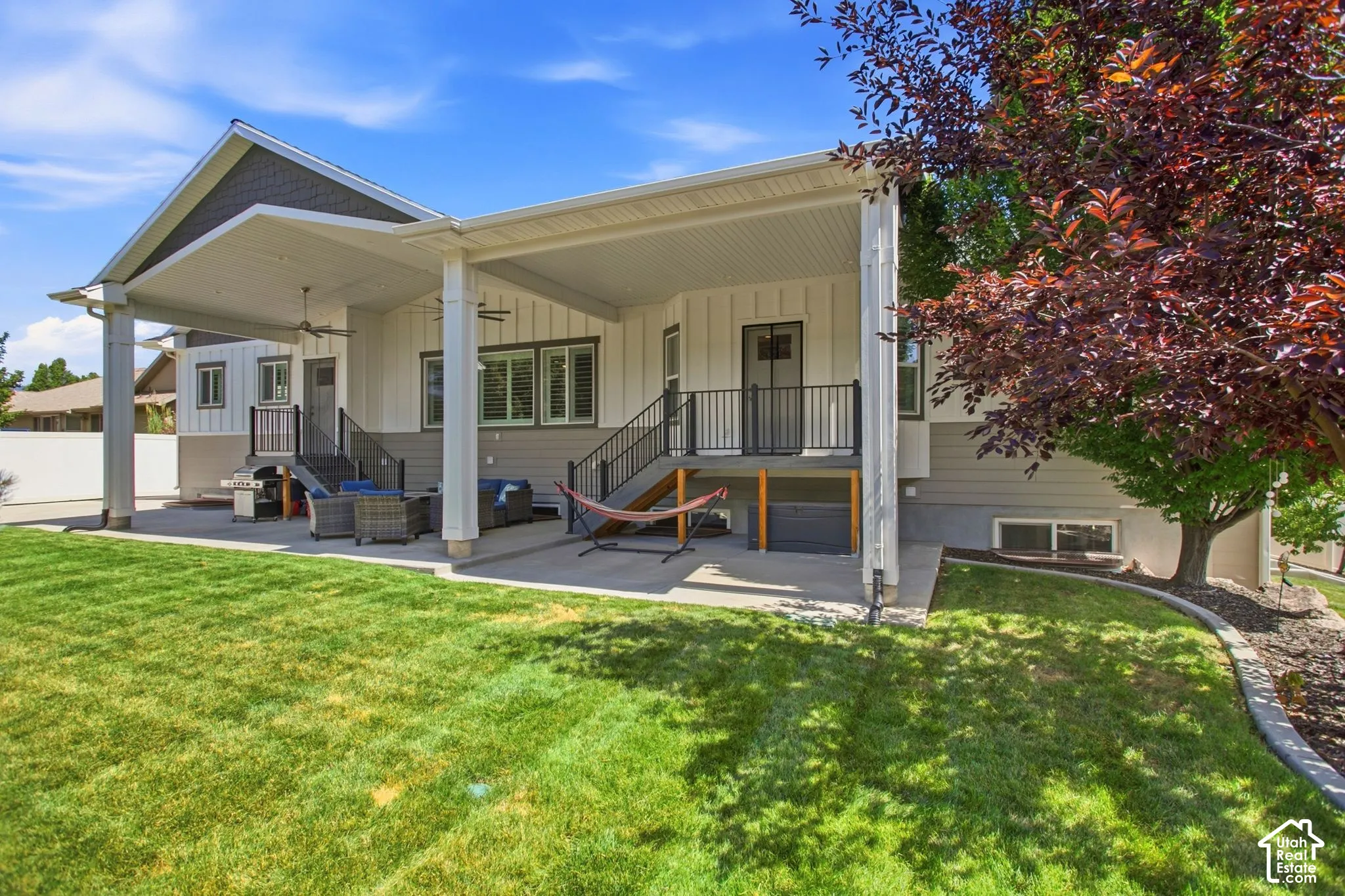 Expansive covered patio with ceiling fans,  and flat fenced yard