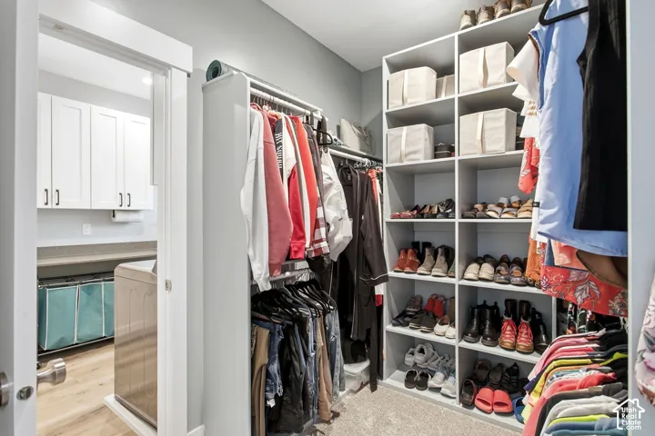 Primary suite walk-in closet-view walking into laundry room