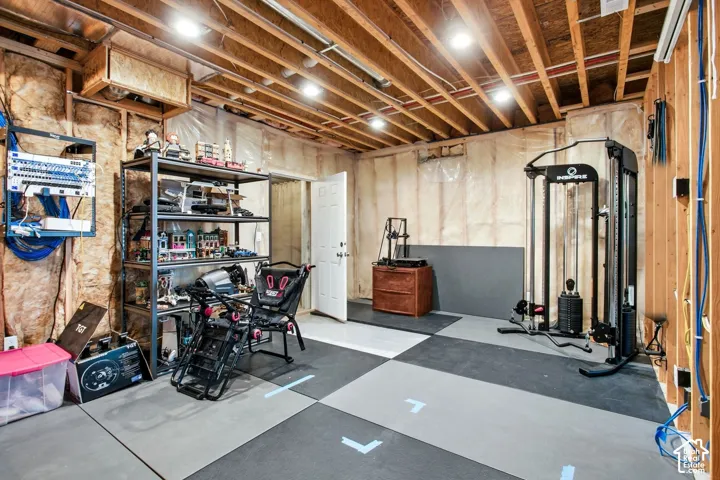 Current lower level-roughed in for gym/flex room- View of door to cold storage