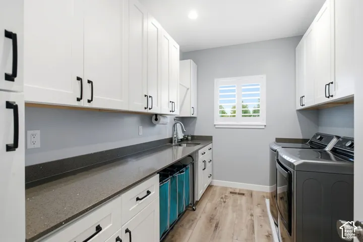 Main level laundry room with under mount sink, large folding counter and cabinets