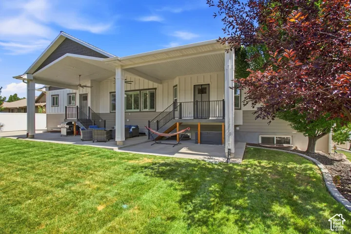 Expansive covered patio with ceiling fans,  and flat fenced yard