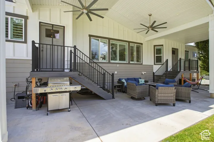 Covered patio with multiple ceiling fans-view of door to kitchen and primary suite