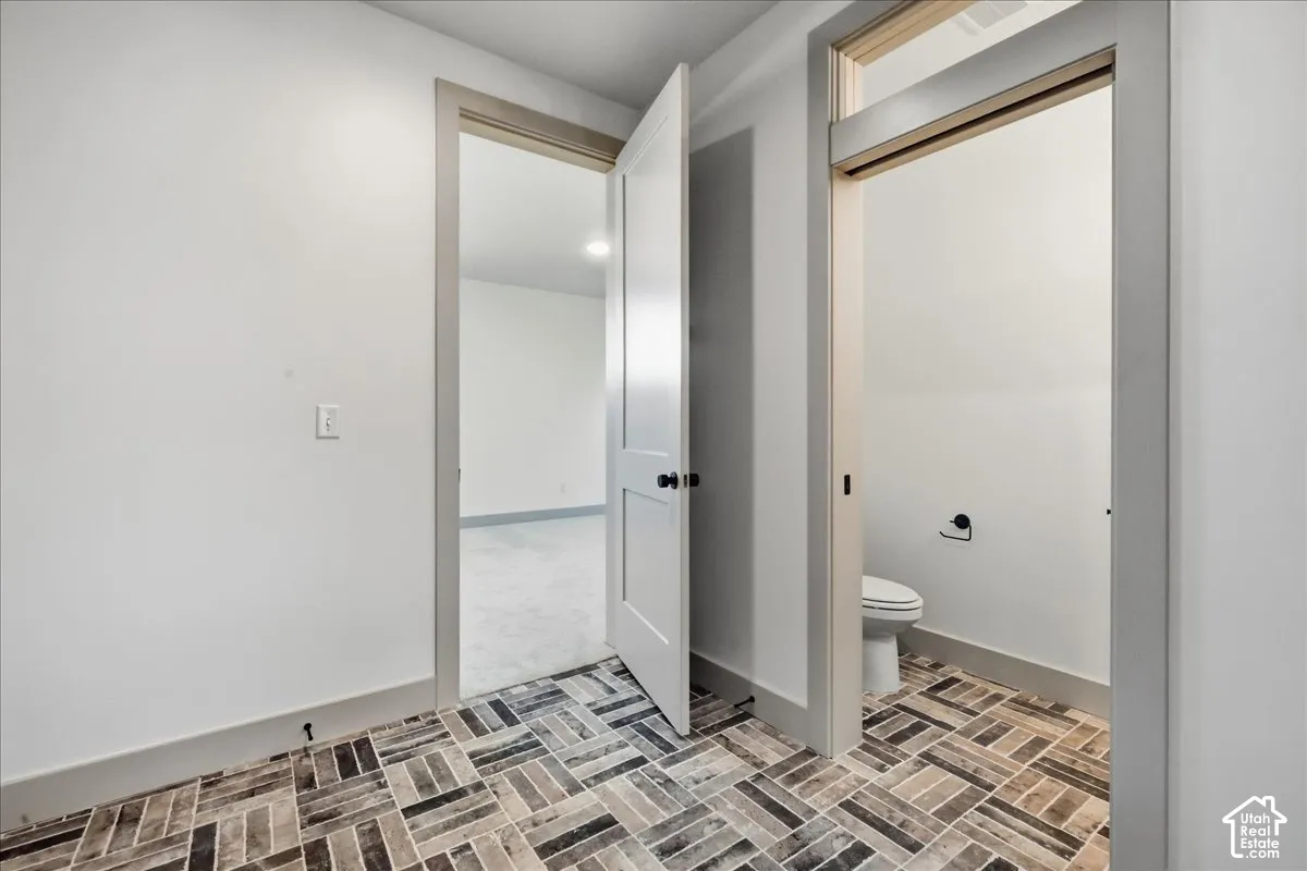 Herringbone pattern tile flooring with a neutral color palette