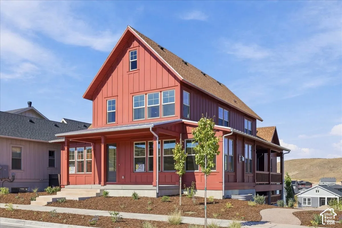 Two-story board and batten exterior with a covered front porch