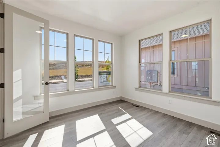 Wood-finish flooring with white walls and trim