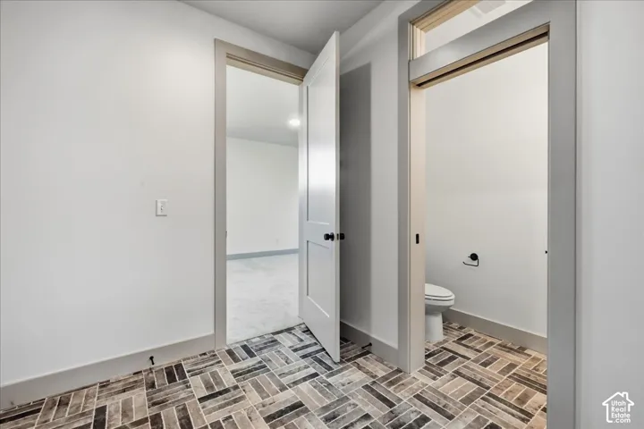 Herringbone pattern tile flooring with a neutral color palette