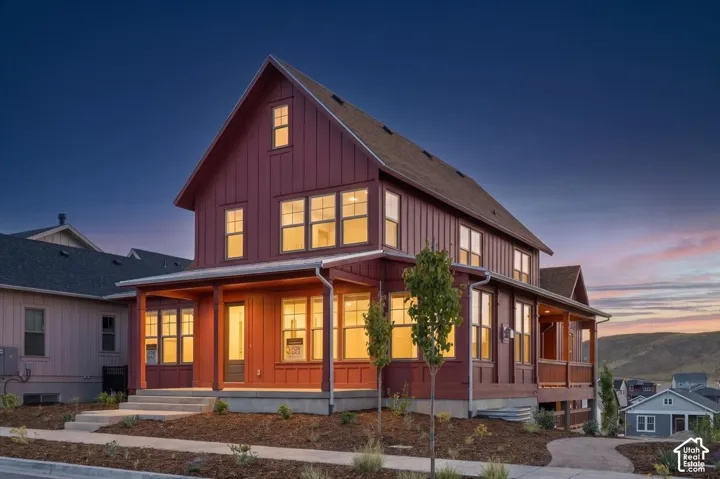Board and batten exterior with an expansive covered front porch and multi-pane windows