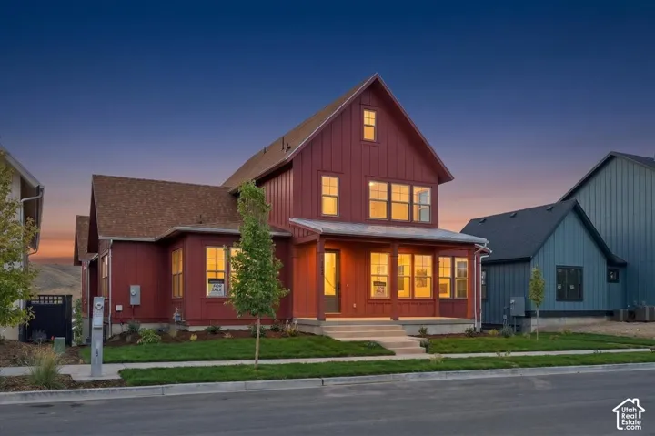 Red vertical siding exterior with gabled roof lines, covered front porch, and multiple windows