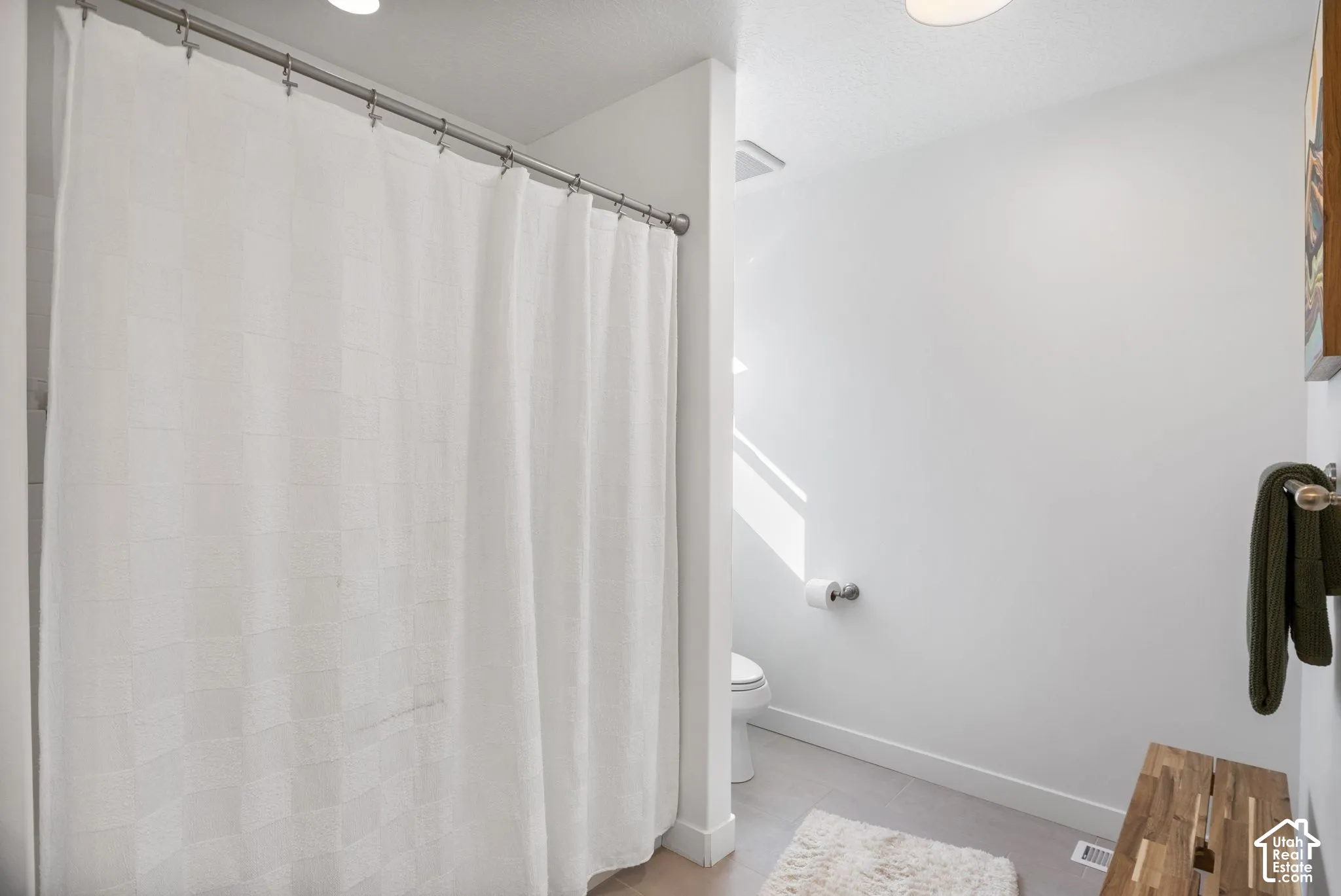 Recessed ceiling lighting, light gray floor tile, and white wall paint