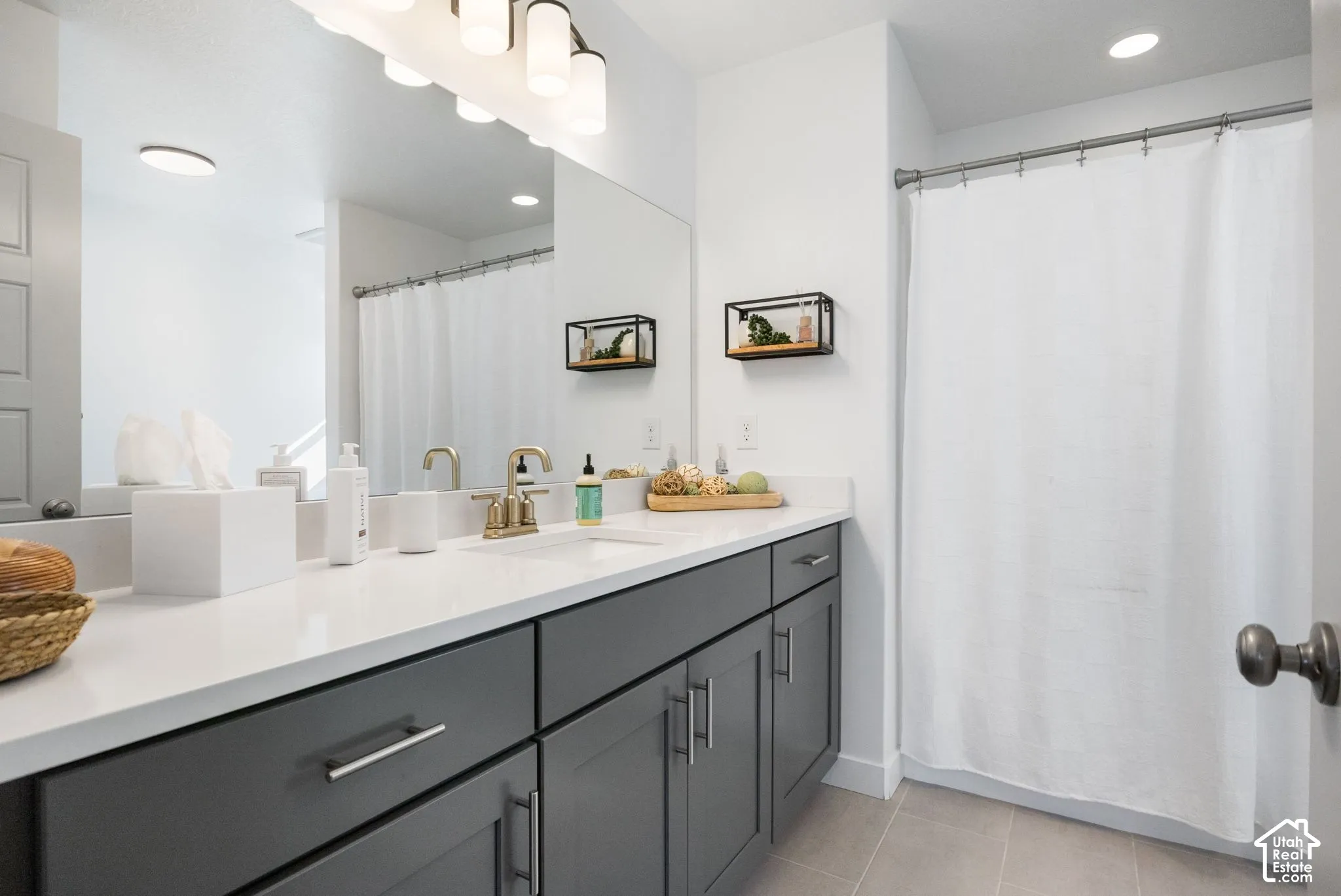 Dual vanity with a white countertop and dark gray cabinetry