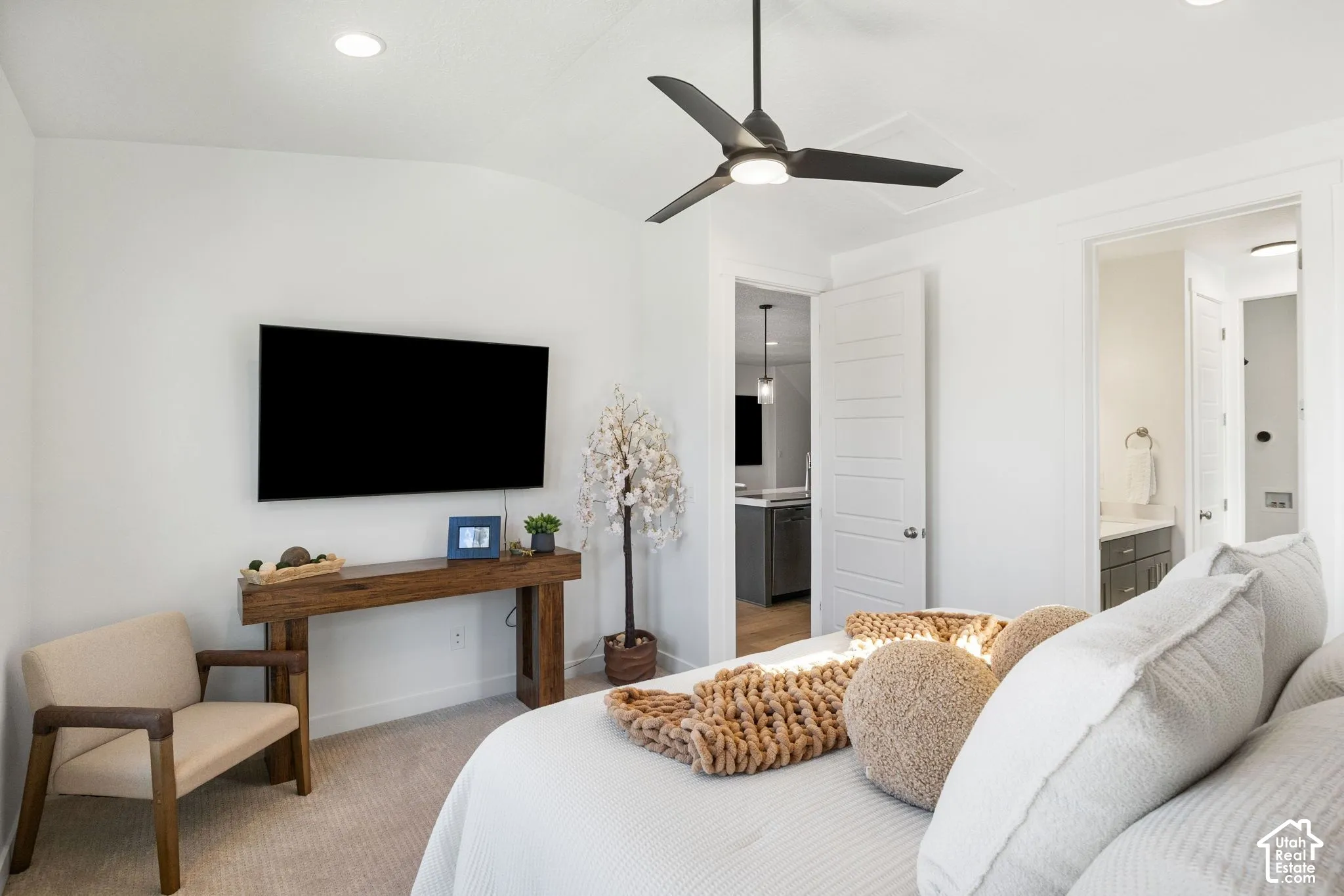 Recessed ceiling lighting, ceiling fan, carpet flooring, flat panel interior doors, and a wood console table