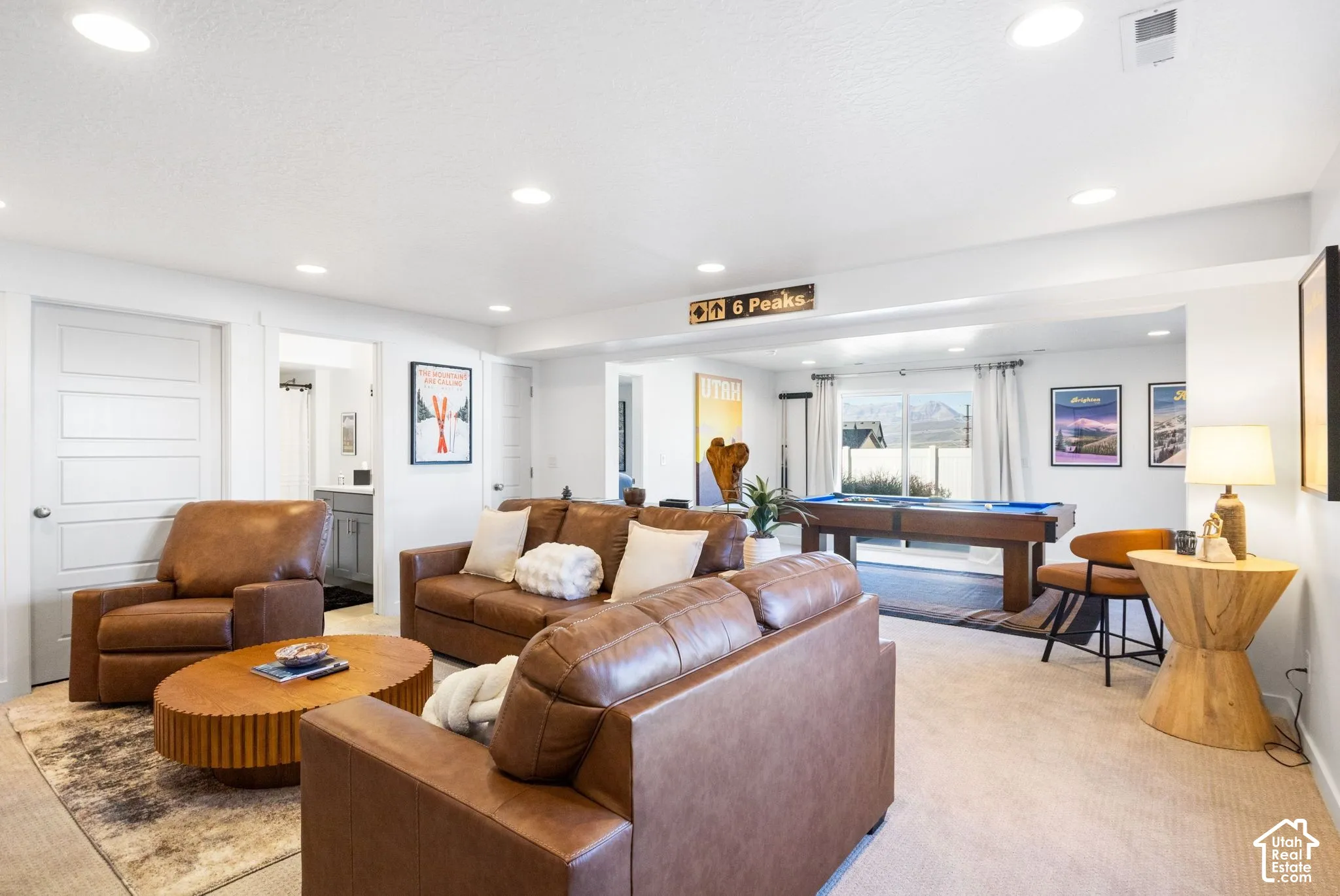 Recessed lighting, light-toned carpeting, and white walls