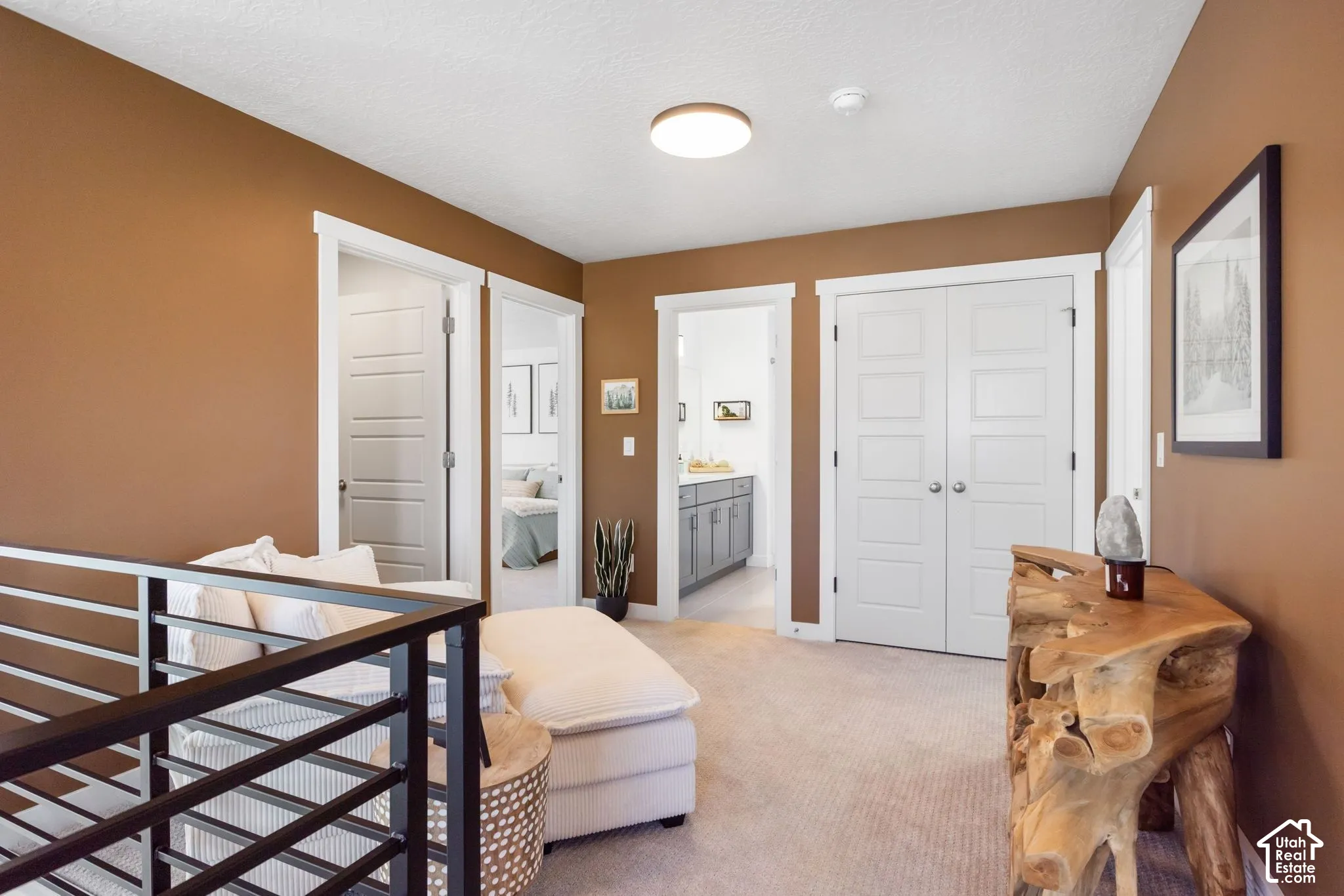 White interior doors, flush mount ceiling light, and neutral tone carpeting