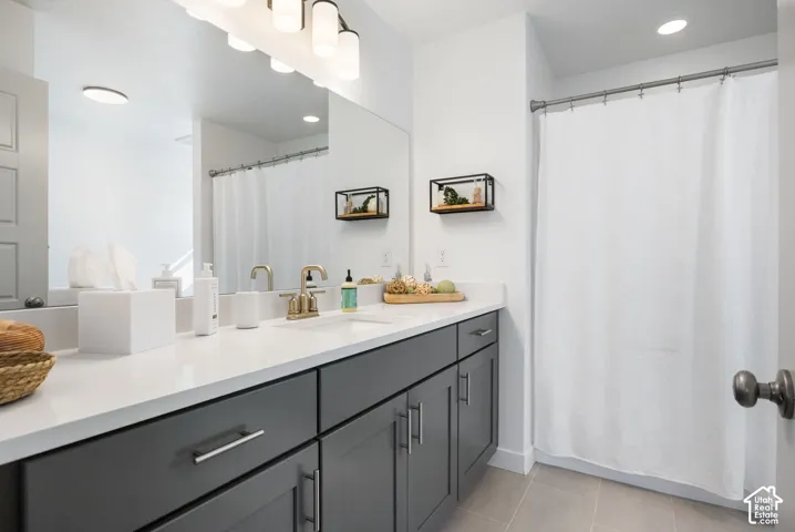 Dual vanity with a white countertop and dark gray cabinetry