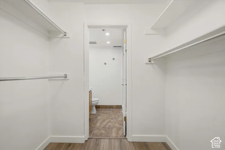 Walk-in closet with integrated shelving and hanging rods